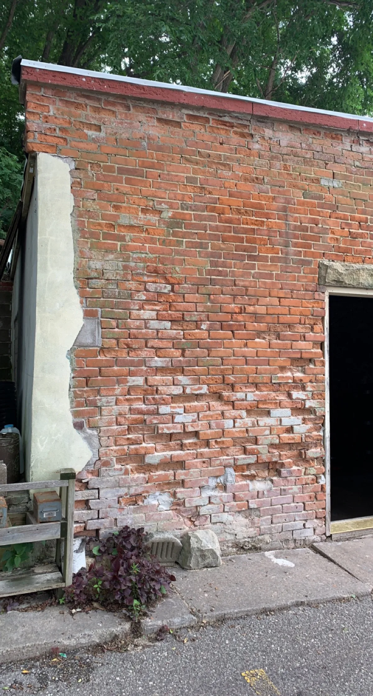 Deteriorated historic brick wall before restoration